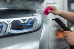 professional-man-covers-car-with-Luminous-protective-film-ppf-uses-steam-tool-detailing-service-care-care-winter-discount