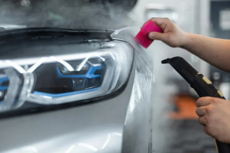 professional-man-covers-car-with-Luminous-protective-film-ppf-uses-steam-tool-detailing-service-care-care-winter-discount