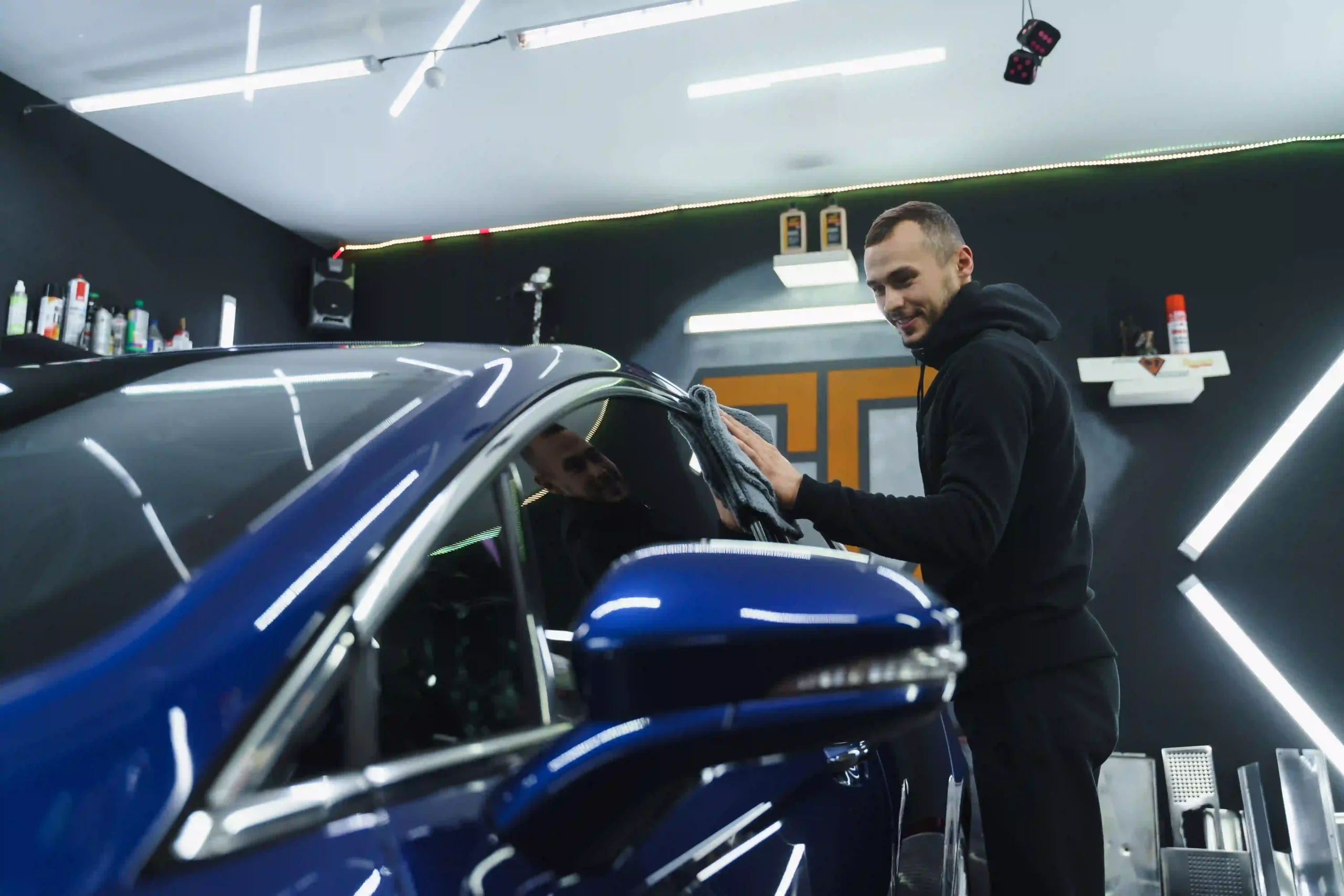 car-polishing-blue-rag-hands-car-detailing-garage- black friday car care windshield protection film