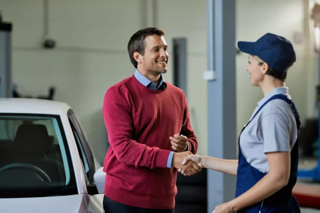 happy-woman-car-care-professional-with-luminous-agent-handshaking-car-care-center happy-woman-car-care-professional-with-luminous-agent-handshaking-car-care-center